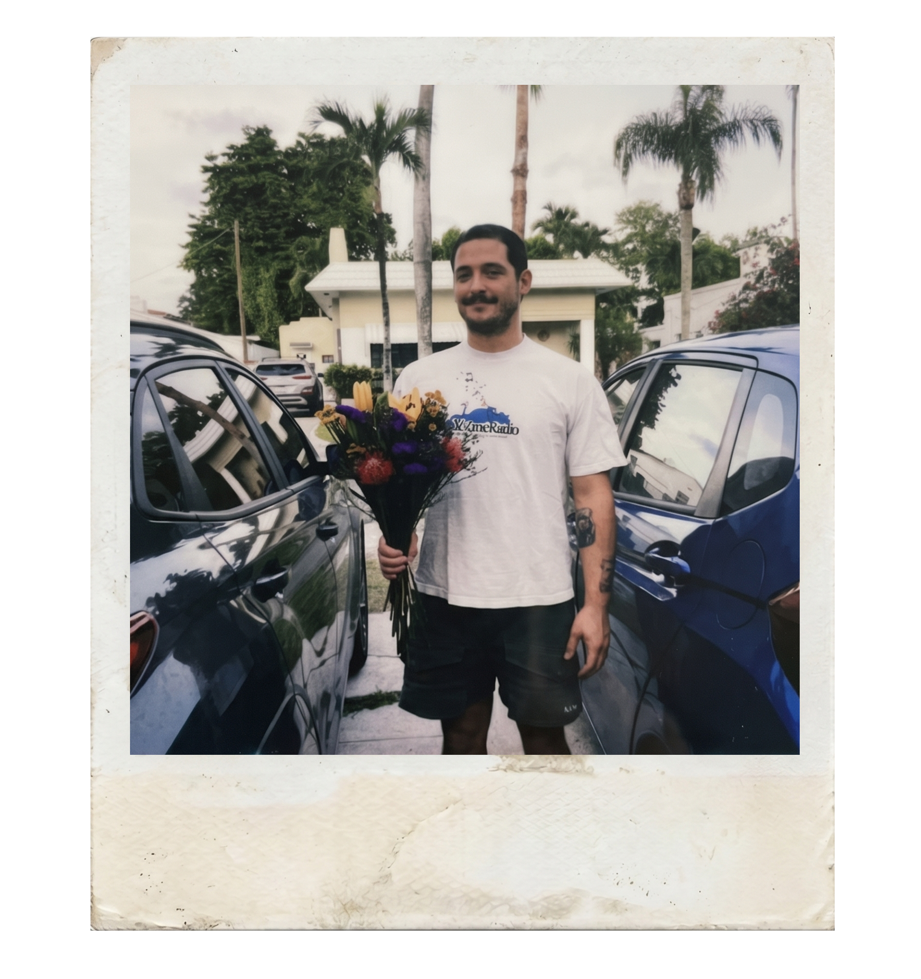 Polaroid of Adrian holding a bouquet of flowers